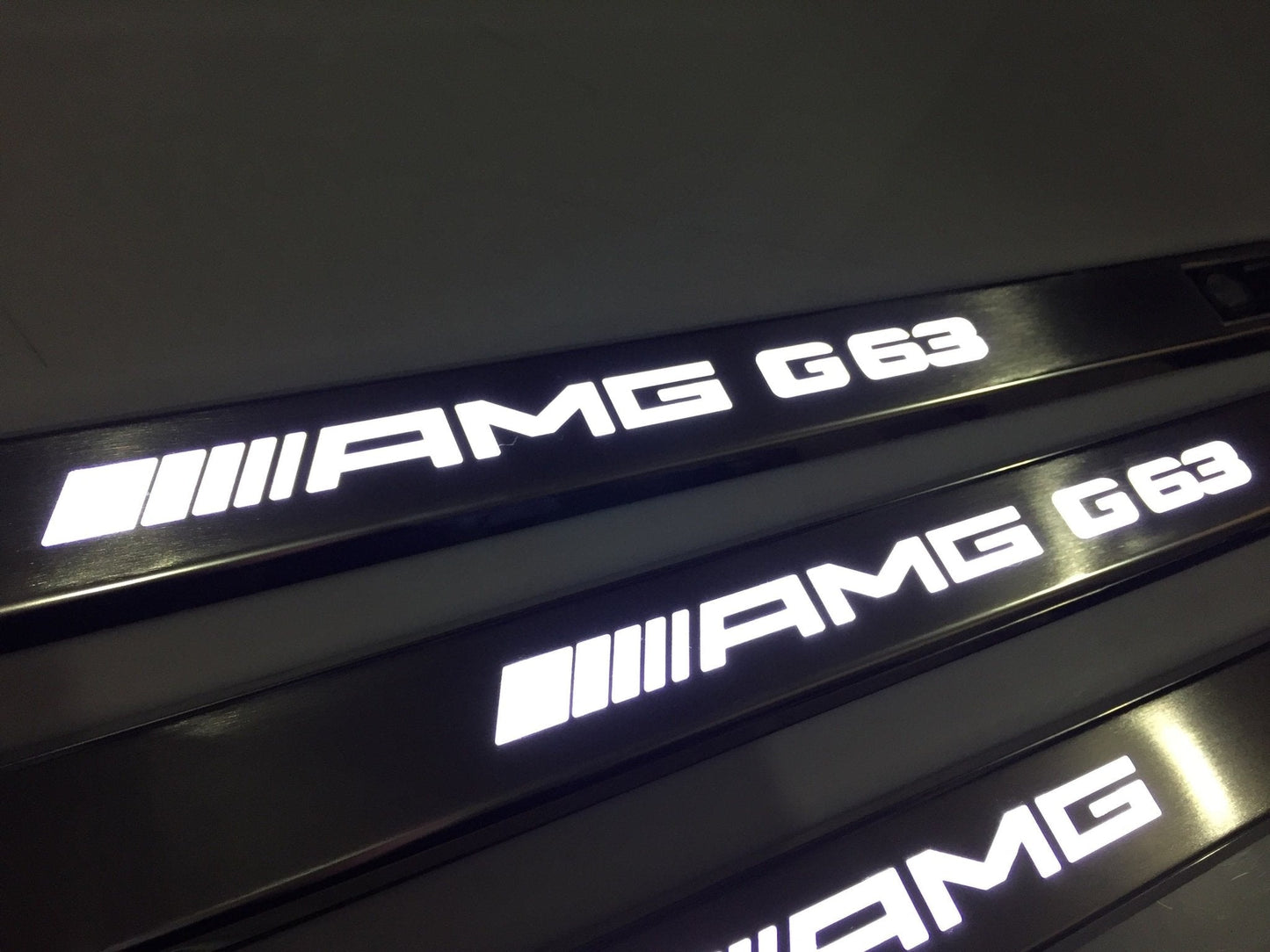 AMG G63 LED Illuminated Door Sills 4 or 5 pcs for Mercedes-Benz G-Class W463 from Tuning Shop, crafted from stainless steel with LED illumination.