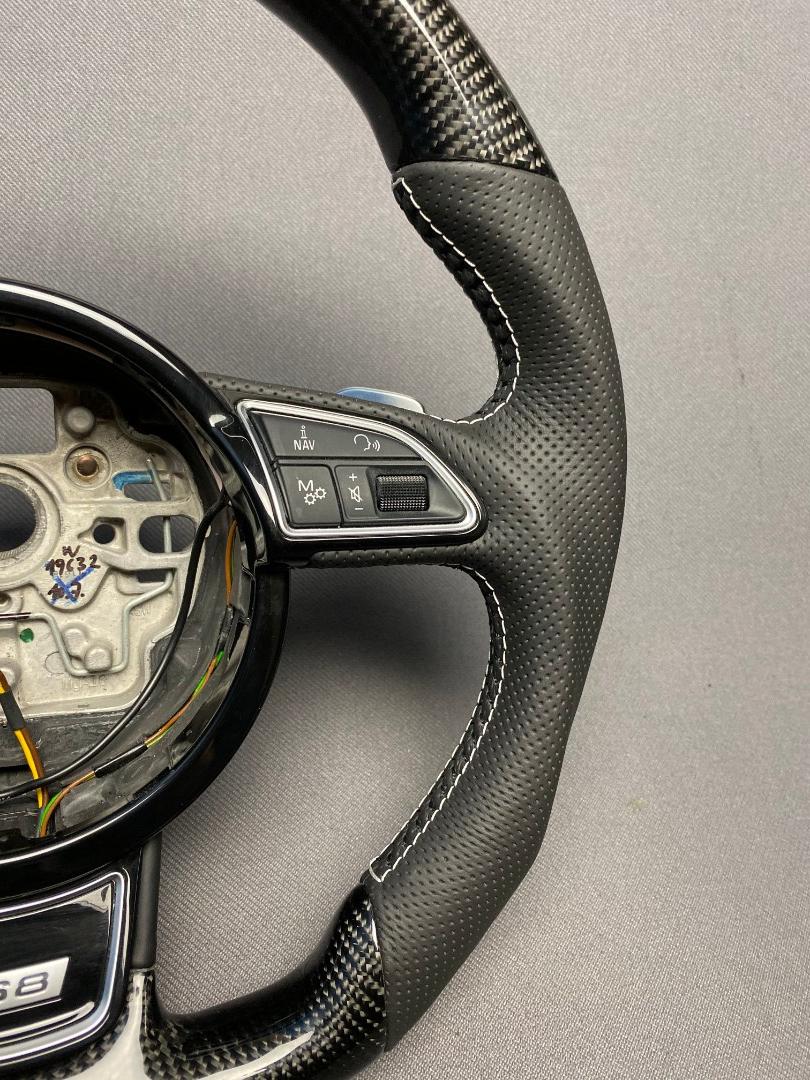 OEM remanufactured Audi S8 steering wheel with carbon fiber, perforated black leather, flat bottom, and piano black center from Tuning Shop.