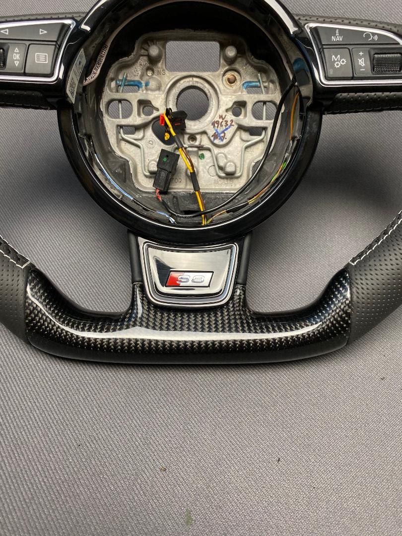 OEM remanufactured Audi S8 steering wheel with carbon fiber, perforated black leather, flat bottom, and piano black center from Tuning Shop.