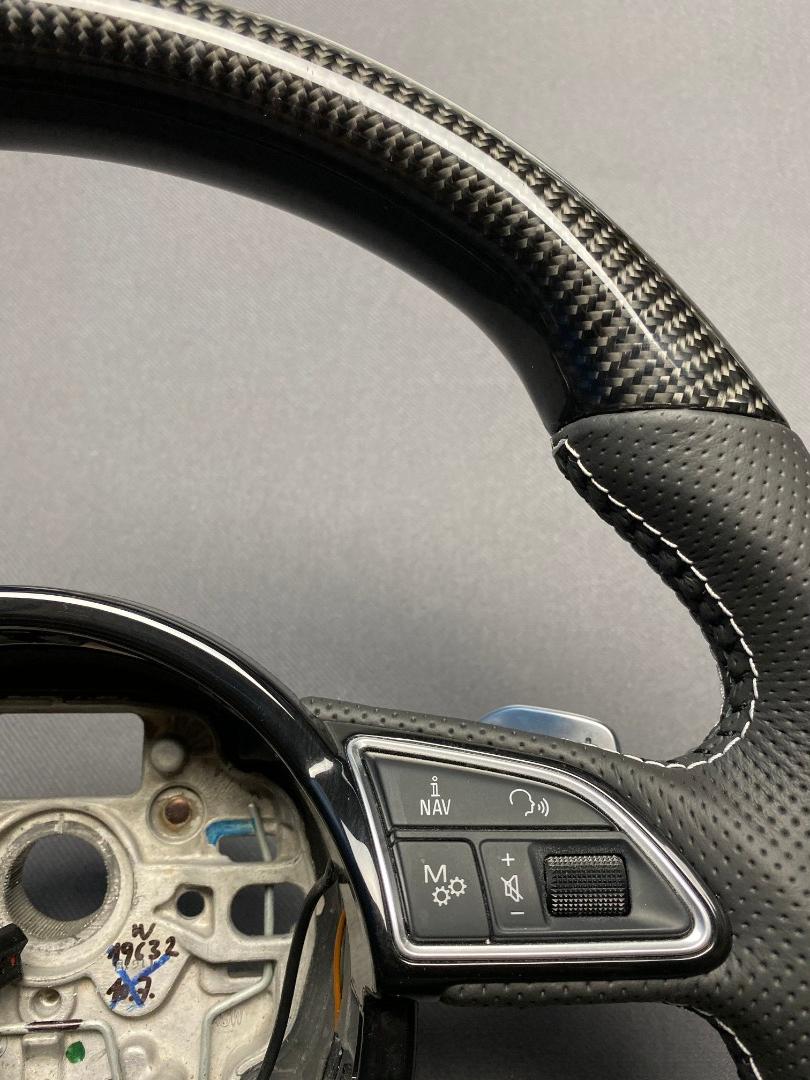 OEM remanufactured Audi S8 steering wheel with carbon fiber, perforated black leather, flat bottom, and piano black center from Tuning Shop.