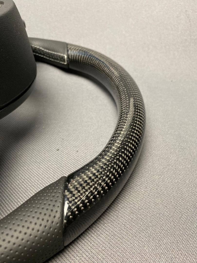 OEM remanufactured Audi S8 steering wheel with carbon fiber, perforated black leather, flat bottom, and piano black center from Tuning Shop.