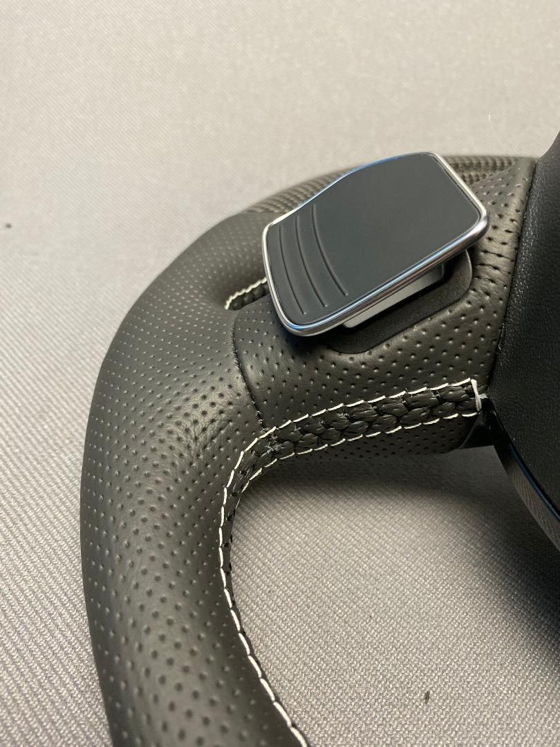 OEM remanufactured Audi S8 steering wheel with carbon fiber, perforated black leather, flat bottom, and piano black center from Tuning Shop.