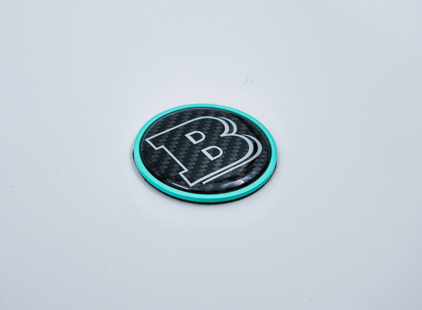 2-component metal carbon Tiffany blue Brabus badge logo emblem 55mm for hood scoop of Mercedes-Benz W463, W463A, W464 G-Class.