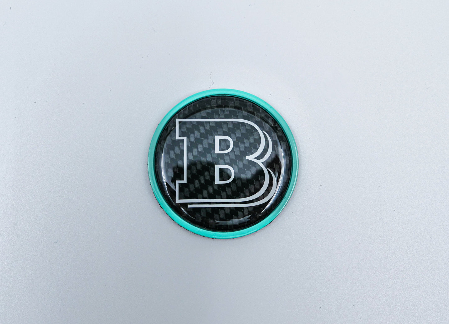 2-component metal carbon Tiffany blue Brabus badge logo emblem 55mm for hood scoop of Mercedes-Benz W463, W463A, W464 G-Class.