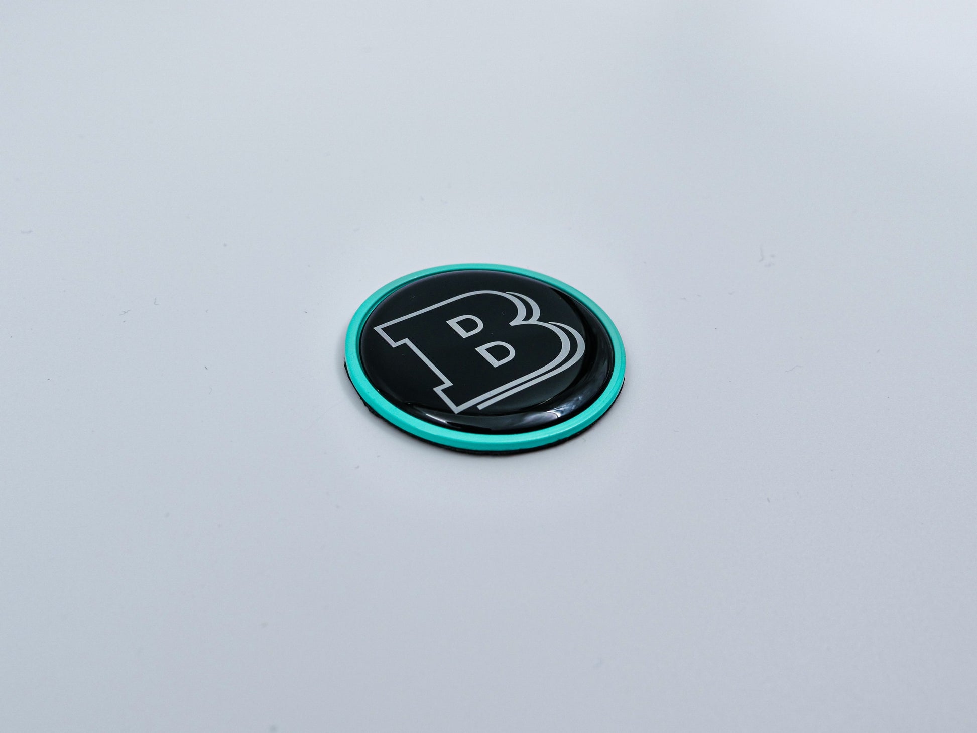 2-component metal Tiffany blue Brabus badge logo emblem 55mm for hood scoop of Mercedes-Benz W463, W463A, W464 G-Class.