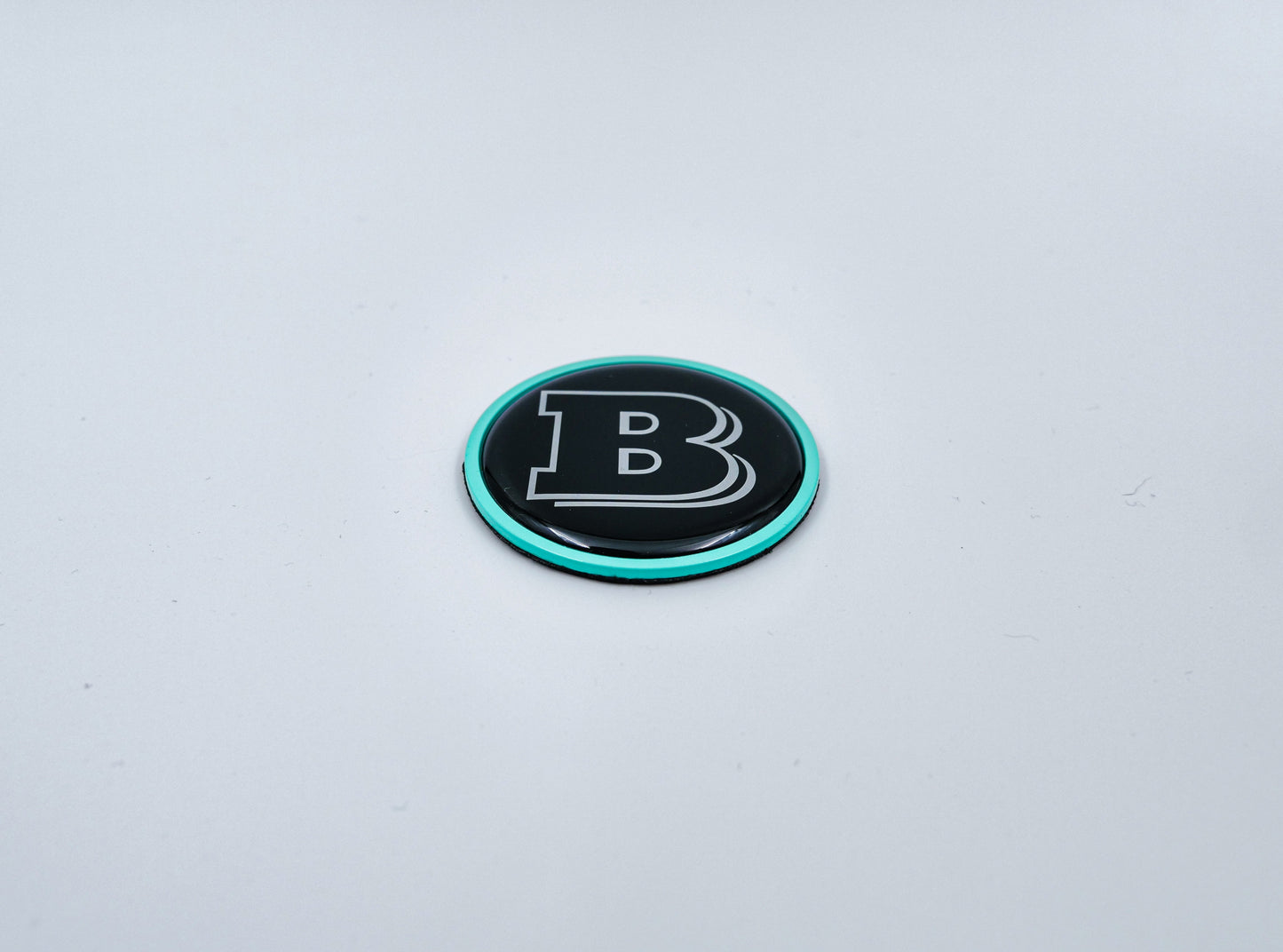 2-component metal Tiffany blue Brabus badge logo emblem 55mm for hood scoop of Mercedes-Benz W463, W463A, W464 G-Class.