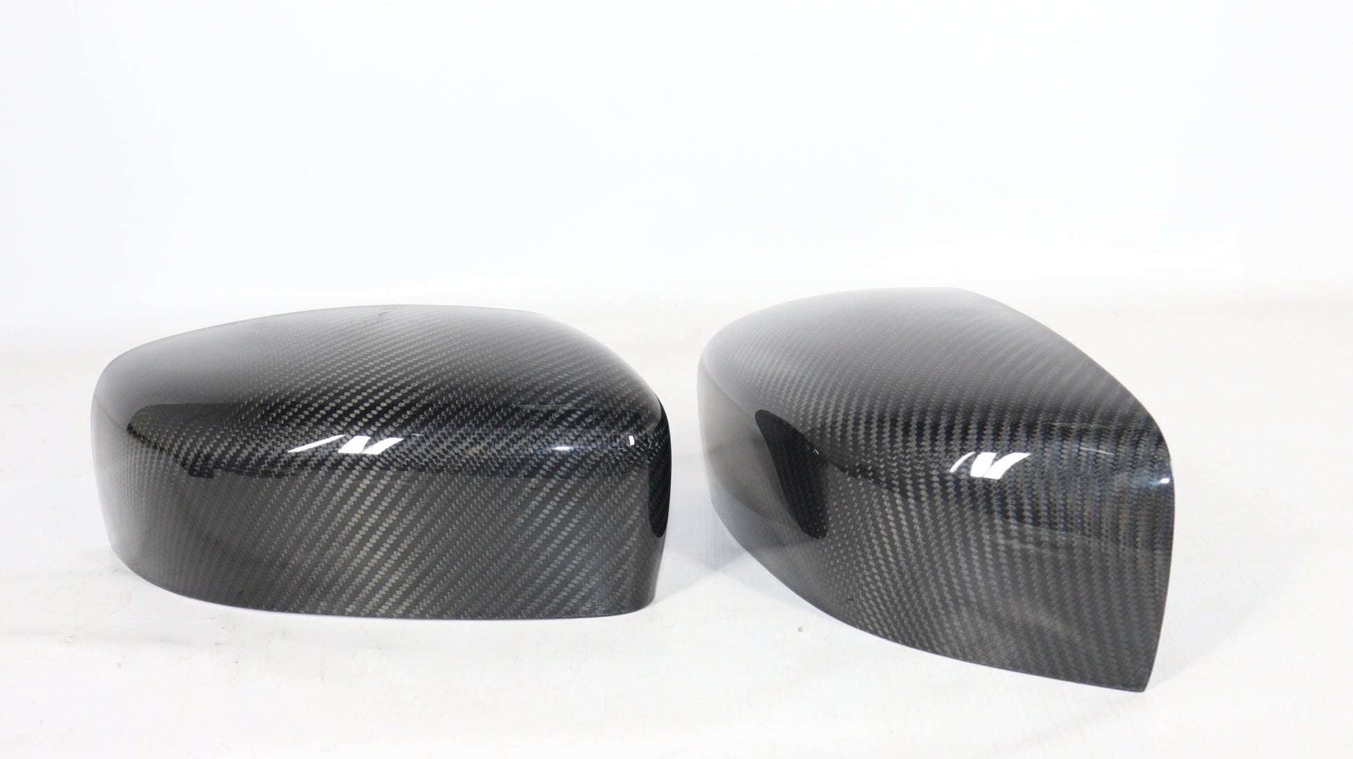 Carbon mirror covers for Maserati Quattroporte Ghibli 2013+ from Tuning Shop, featuring genuine carbon fiber with a high-gloss UV-resistant coating.