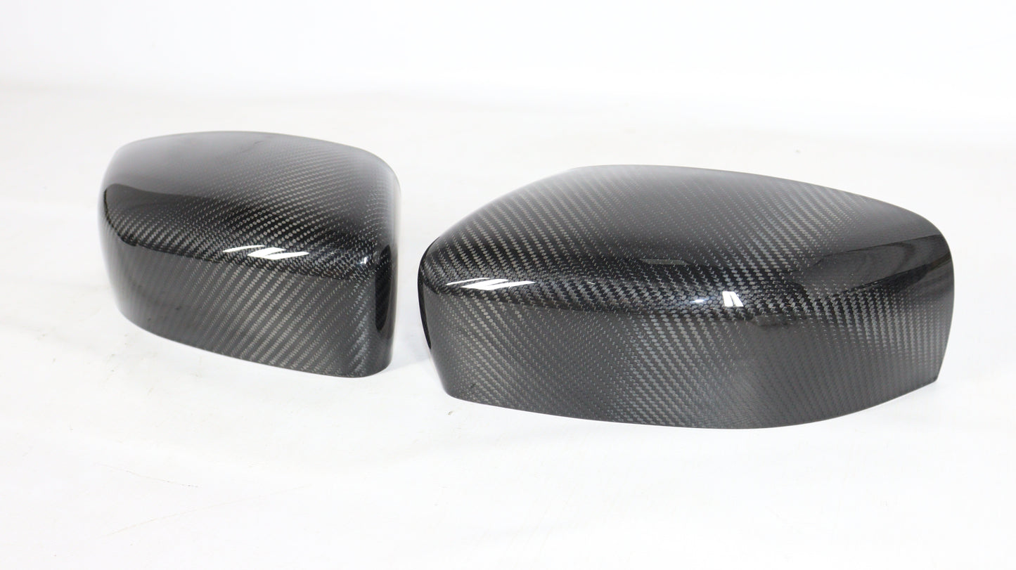 Carbon mirror covers for Maserati Quattroporte Ghibli 2013+ from Tuning Shop, featuring genuine carbon fiber with a high-gloss UV-resistant coating.