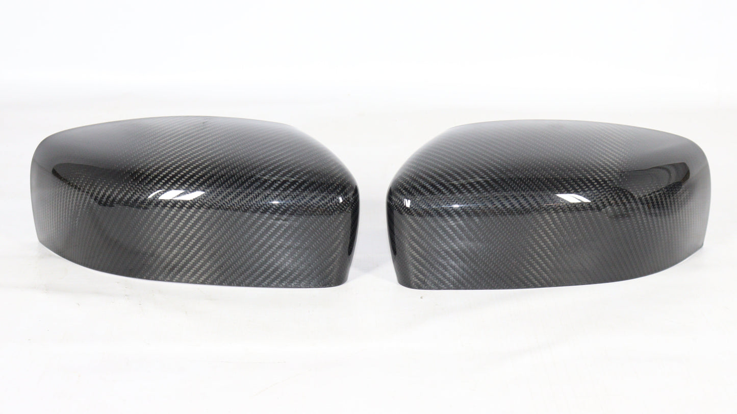 Carbon mirror covers for Maserati Quattroporte Ghibli 2013+ from Tuning Shop, featuring genuine carbon fiber with a high-gloss UV-resistant coating.