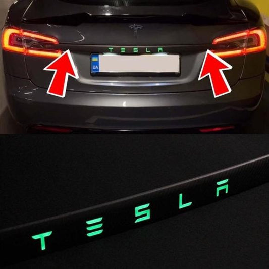 Carbon rear trunk trim with LEDs for Tesla Model S from Tuning Shop, made of genuine carbon fiber with a grey gloss UV-resistant coating.