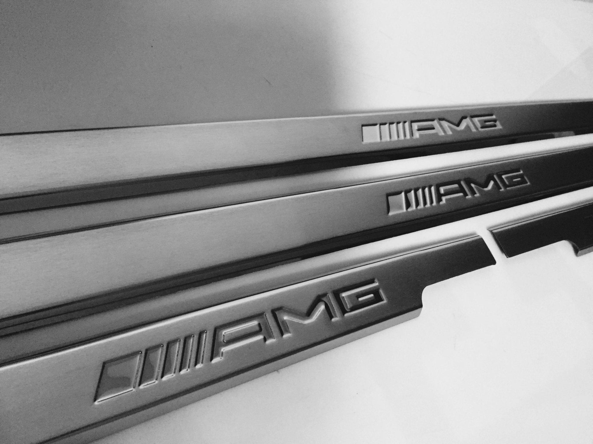 AMG Door Sills 4 or 5 pcs for Mercedes-Benz G-Class W463 from Tuning Shop, crafted from stainless steel with a sleek design.