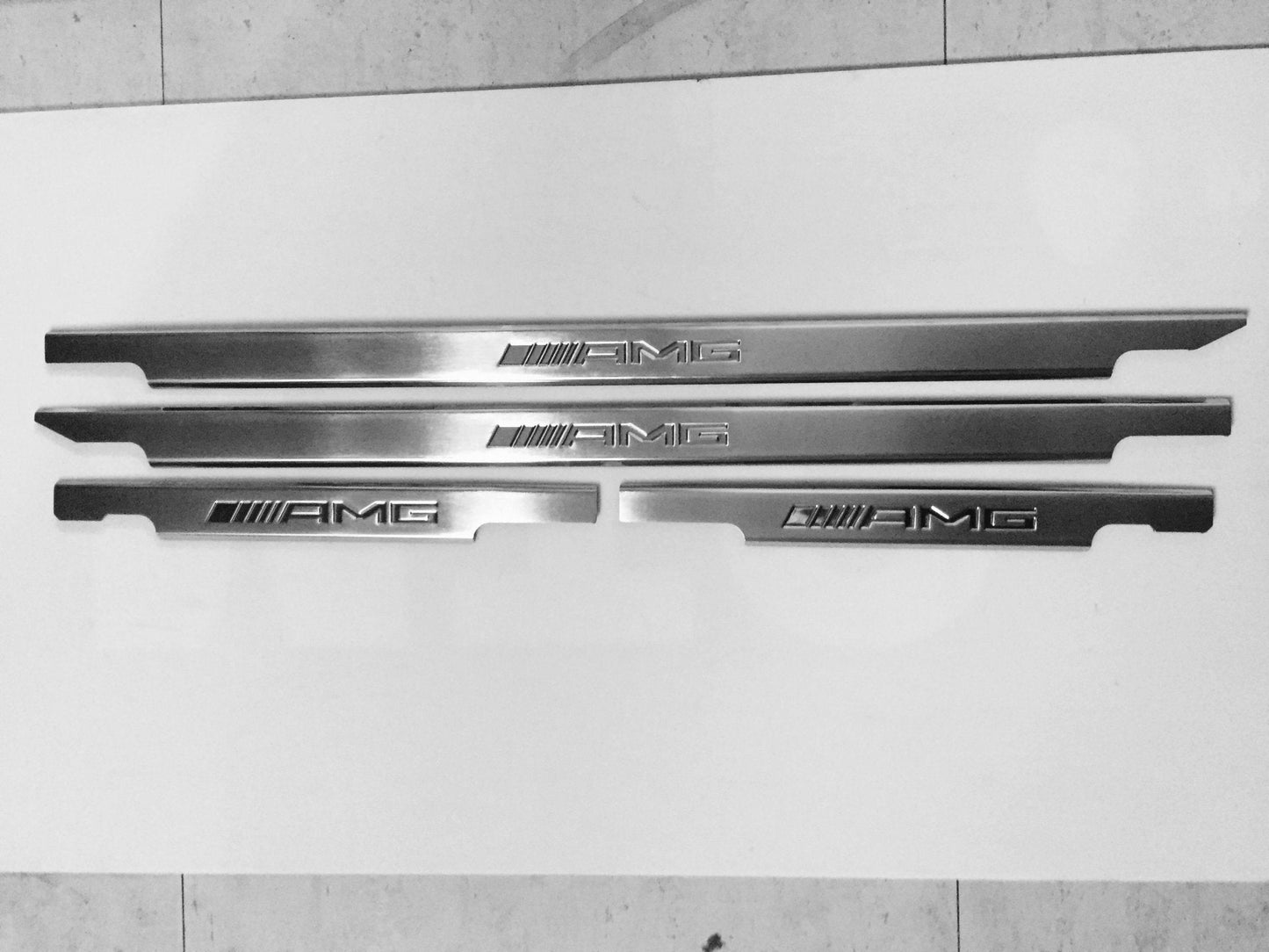 AMG Door Sills 4 or 5 pcs for Mercedes-Benz G-Class W463 from Tuning Shop, crafted from stainless steel with a sleek design.