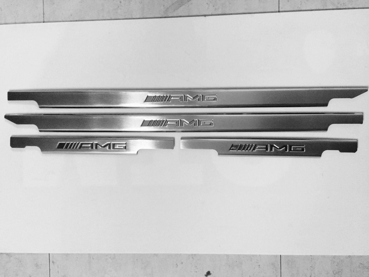 AMG Door Sills 4 or 5 pcs for Mercedes-Benz G-Class W463 from Tuning Shop, crafted from stainless steel with a sleek design.