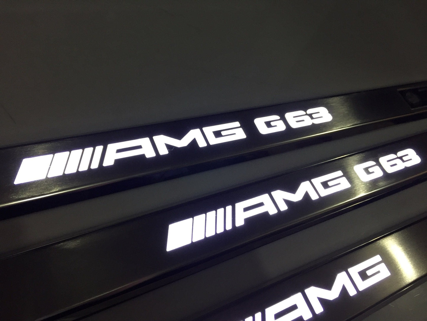 AMG G63 LED Illuminated Door Sills 4 or 5 pcs for Mercedes-Benz G-Class W463 from Tuning Shop, crafted from stainless steel with LED illumination.
