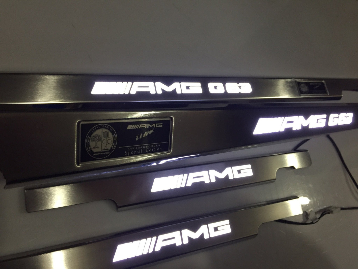 AMG G63 LED Illuminated Door Sills 4 or 5 pcs for Mercedes-Benz G-Class W463 from Tuning Shop, crafted from stainless steel with LED illumination.