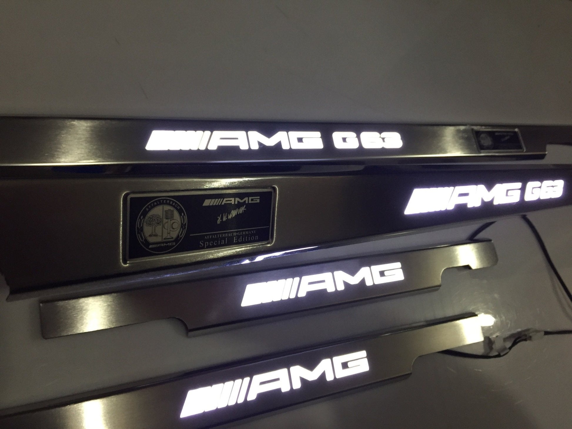 AMG G63 LED Illuminated Door Sills 4 or 5 pcs for Mercedes-Benz G-Class W463 from Tuning Shop, crafted from stainless steel with LED illumination.