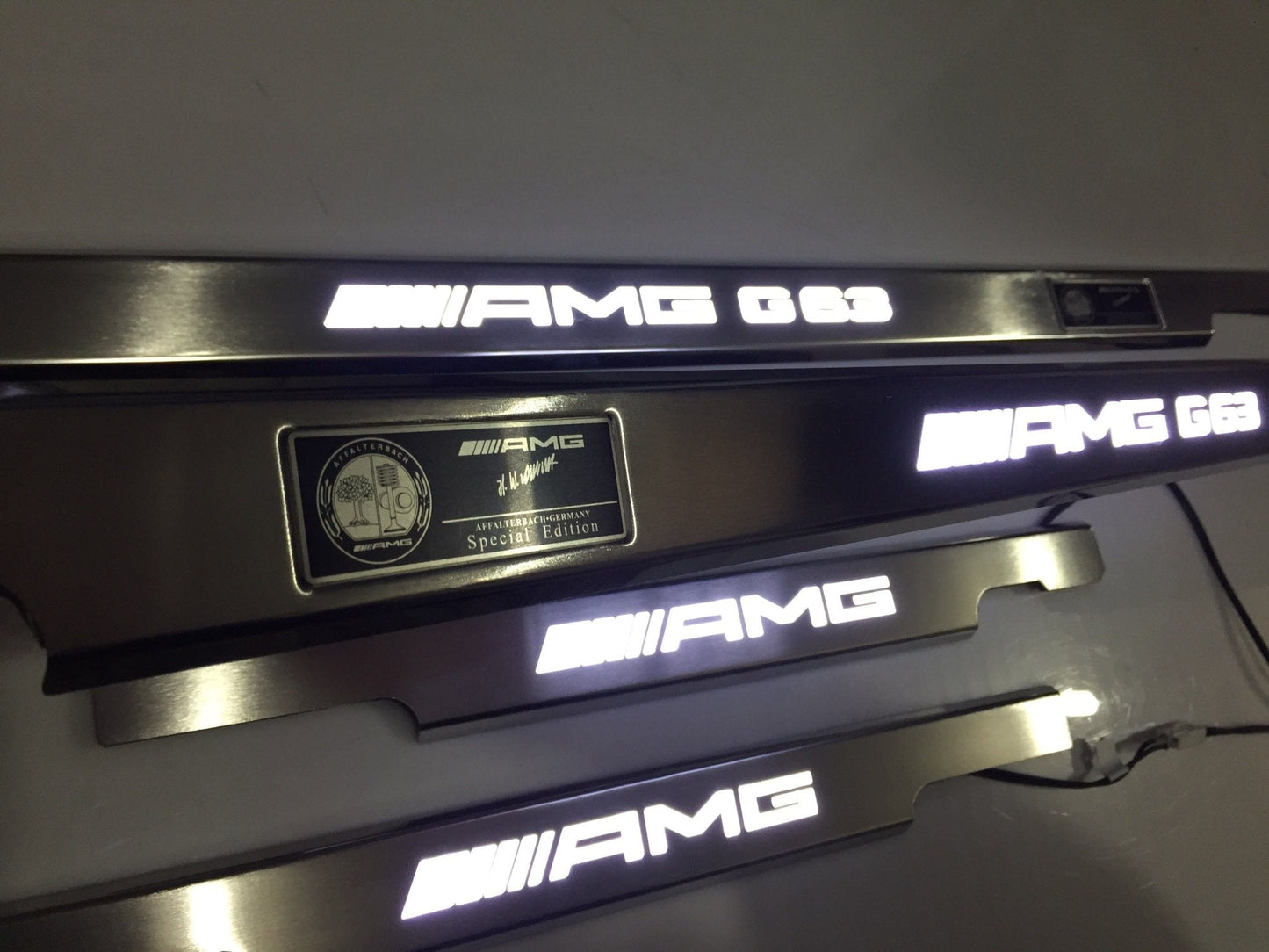 AMG G63 LED Illuminated Door Sills 4 or 5 pcs for Mercedes-Benz G-Class W463 from Tuning Shop, crafted from stainless steel with LED illumination.