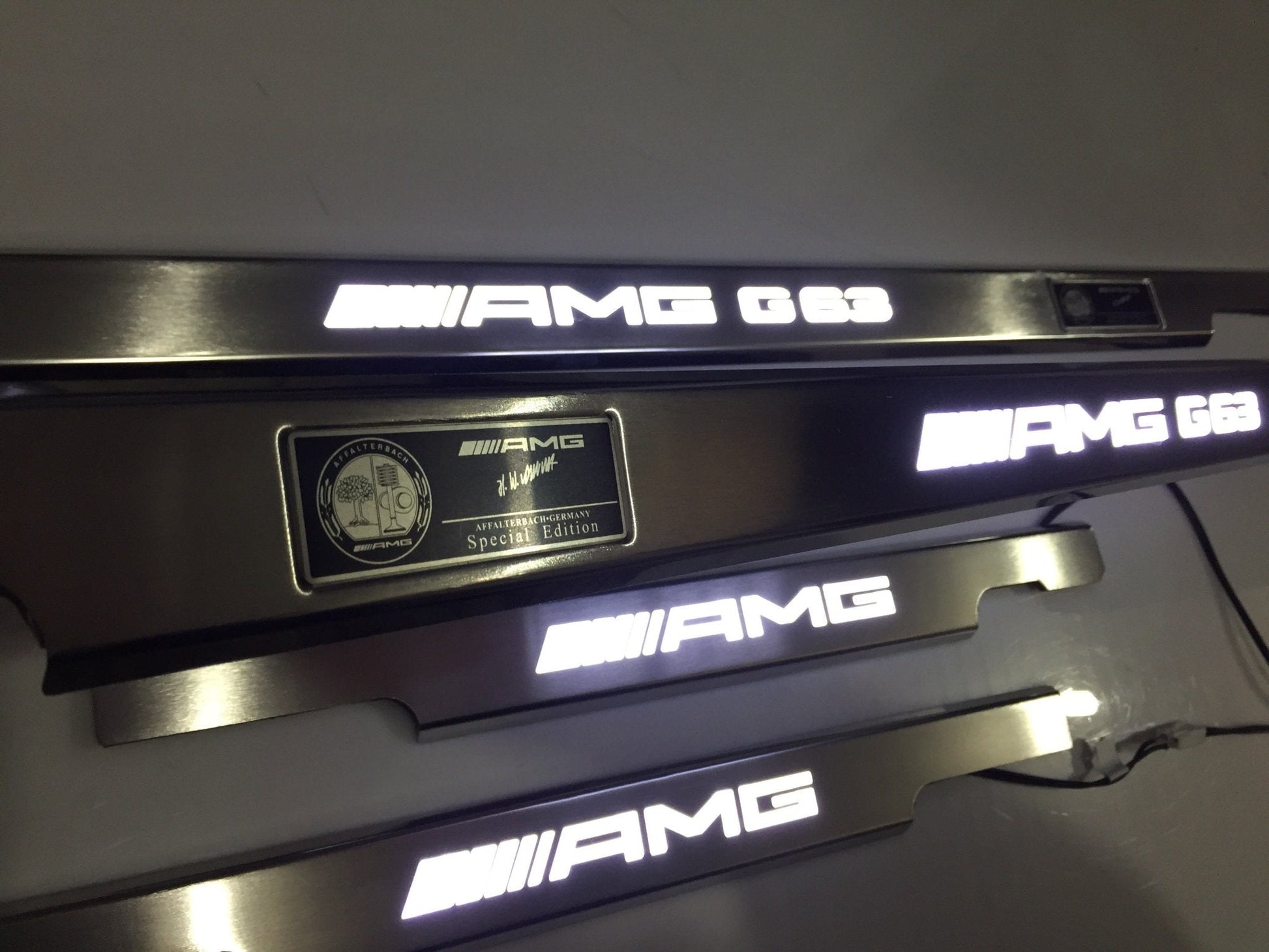 AMG G63 LED Illuminated Door Sills 4 or 5 pcs for Mercedes-Benz G-Class W463 from Tuning Shop, crafted from stainless steel with LED illumination.