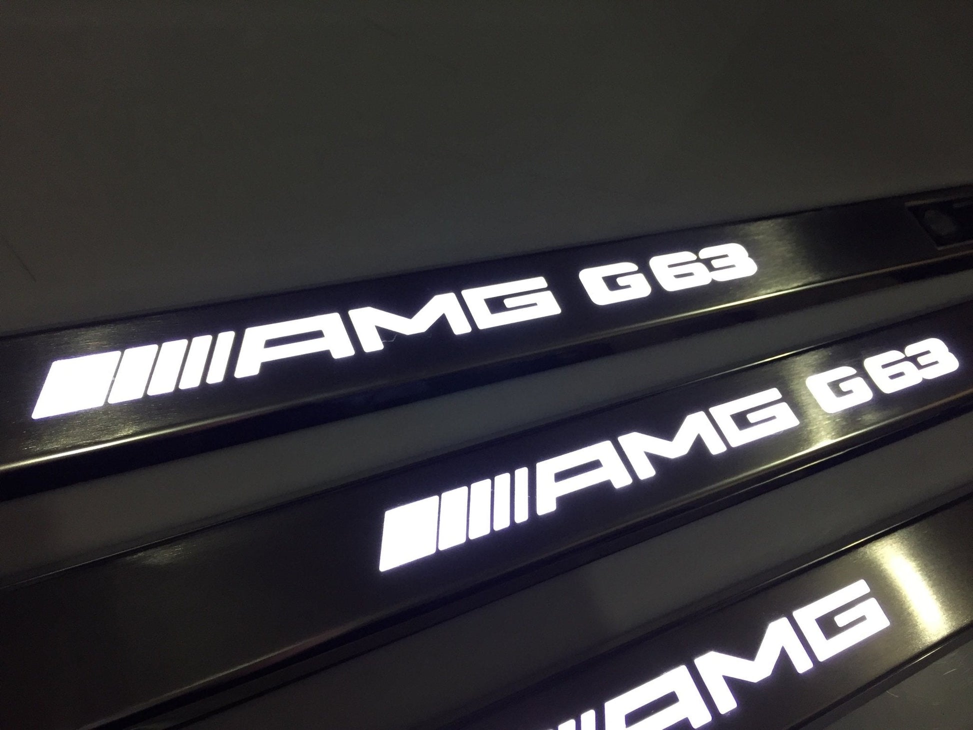 AMG G63 LED Illuminated Door Sills 4 or 5 pcs for Mercedes-Benz G-Class W463 from Tuning Shop, crafted from stainless steel with LED illumination.