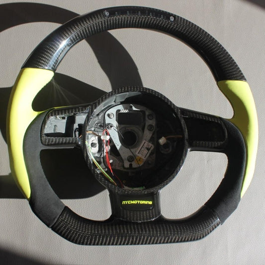 OEM remanufactured Audi R8 steering wheel with carbon fiber, yellow leather, alcantara, flat bottom, and LED panel from Tuning Shop.