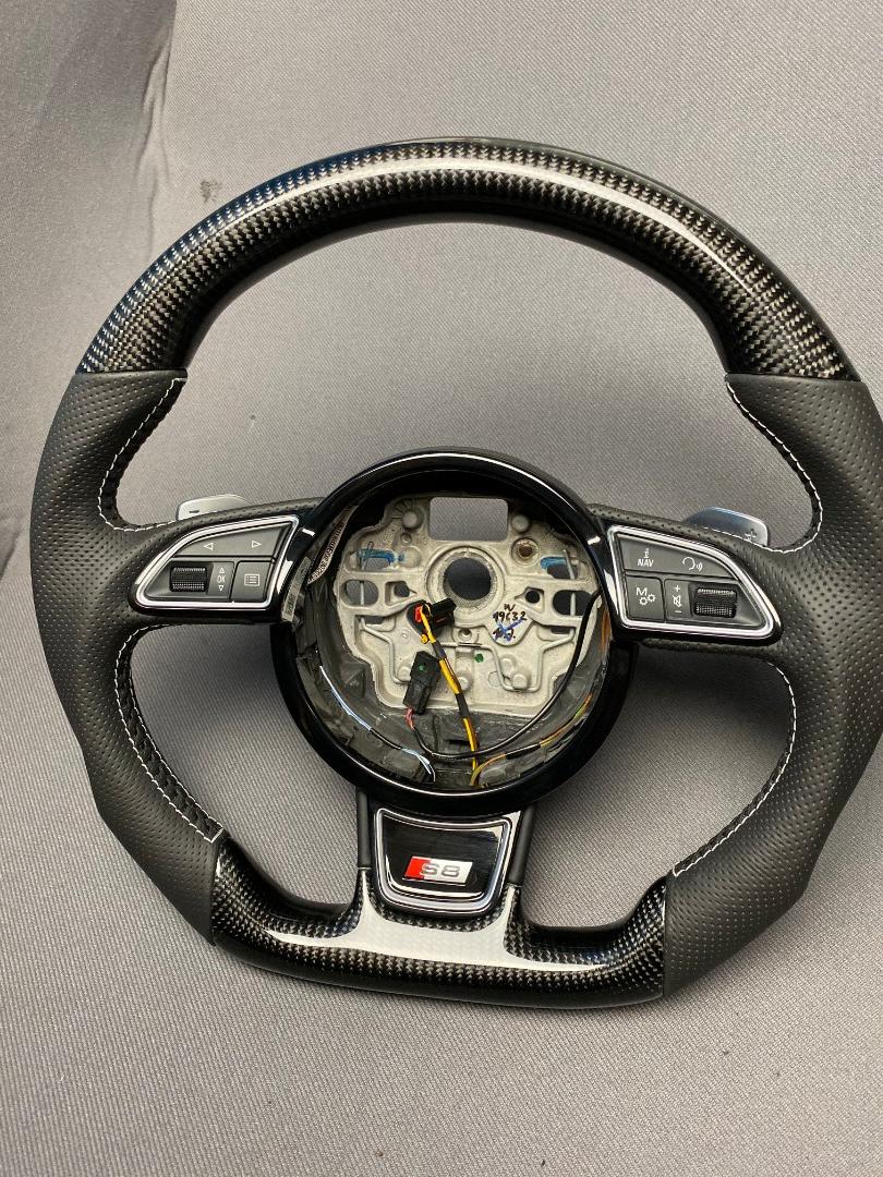 OEM remanufactured Audi S8 steering wheel with carbon fiber, perforated black leather, flat bottom, and piano black center from Tuning Shop.