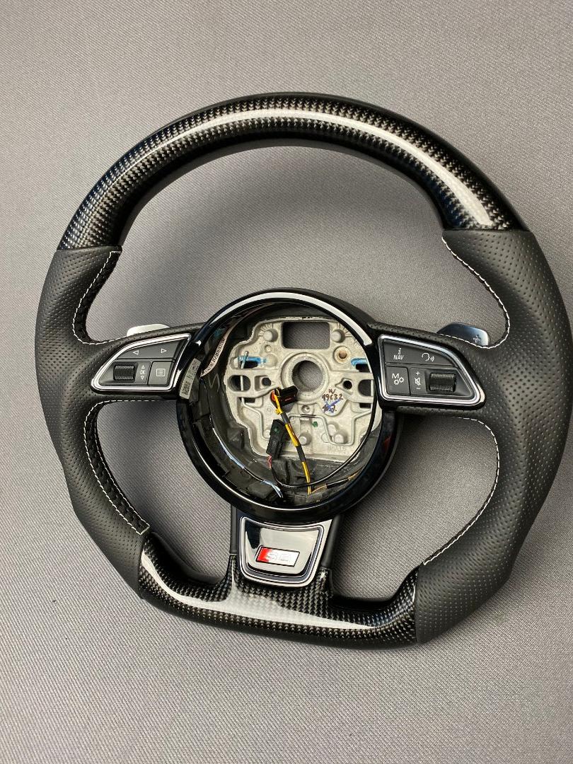 OEM remanufactured Audi S8 steering wheel with carbon fiber, perforated black leather, flat bottom, and piano black center from Tuning Shop.