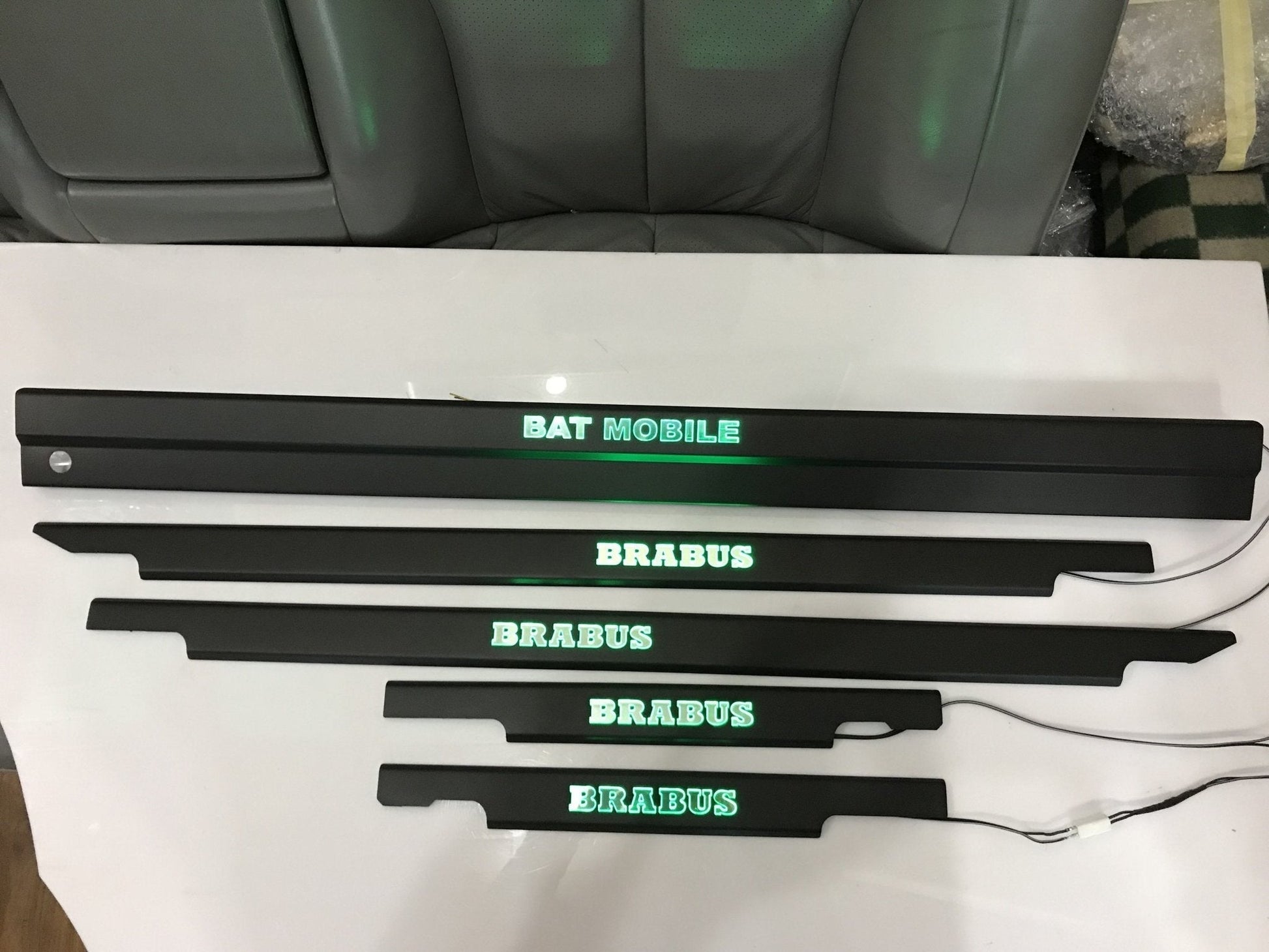 Bat Mobile Brabus style LED illuminated door sills, 4 or 5 pcs, for Mercedes-Benz G-Class W463 from Tuning Shop, featuring stainless steel construction and blue or orange sign colors.