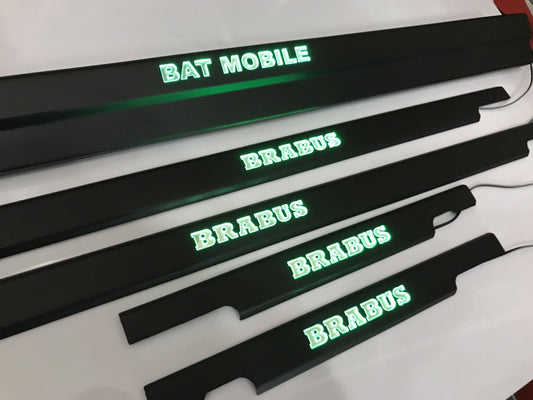 Bat Mobile Brabus style LED illuminated door sills, 4 or 5 pcs, for Mercedes-Benz G-Class W463 from Tuning Shop, featuring stainless steel construction and blue or orange sign colors.