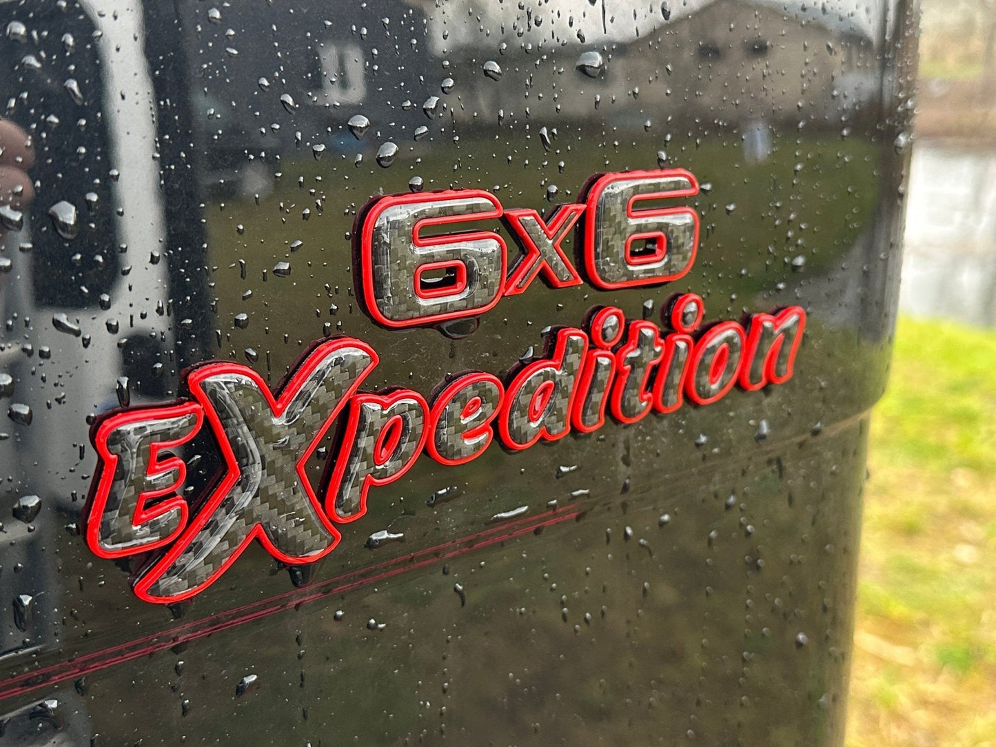 6x6 Expedition Emblem Logo 2-Component Red Metal with Carbon for Mercedes W463 6x6 from Tuning Shop, high-quality metal and carbon construction.